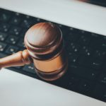 wooden gavel on a black keyboard